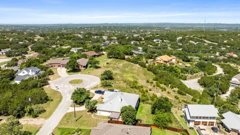 an aerial view of residential houses with city view