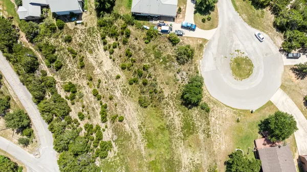 a view of a lush green forest with houses