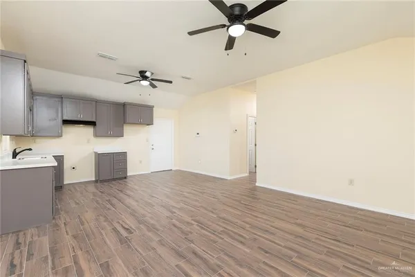 a view of a kitchen with a dishwasher and wooden floor