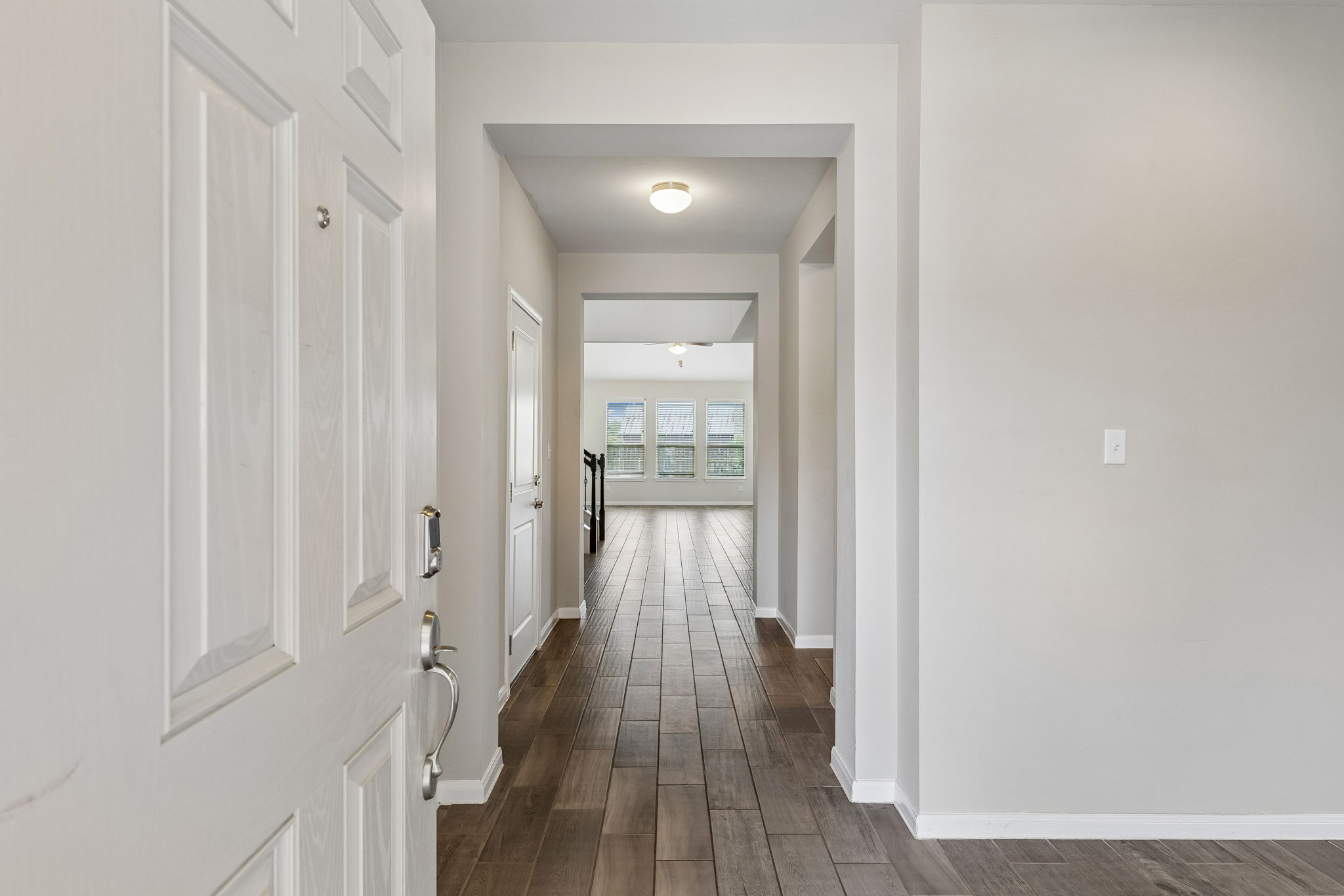 301 Rimrock Court Bastrop, TX 78602 - Photo 4 of 21 Step into a home featuring stylish plank tile flooring that extends throughout, creating a unified and inviting atmosphere.