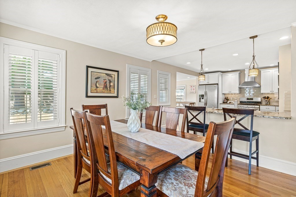 7 Perkins Avenue Reading, MA 01867 - Photo 12 of 42 a view of a dining room with furniture and wooden floor