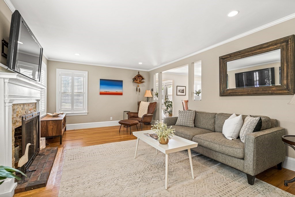 7 Perkins Avenue Reading, MA 01867 - Photo 21 of 42 a living room with furniture a fireplace and a flat screen tv