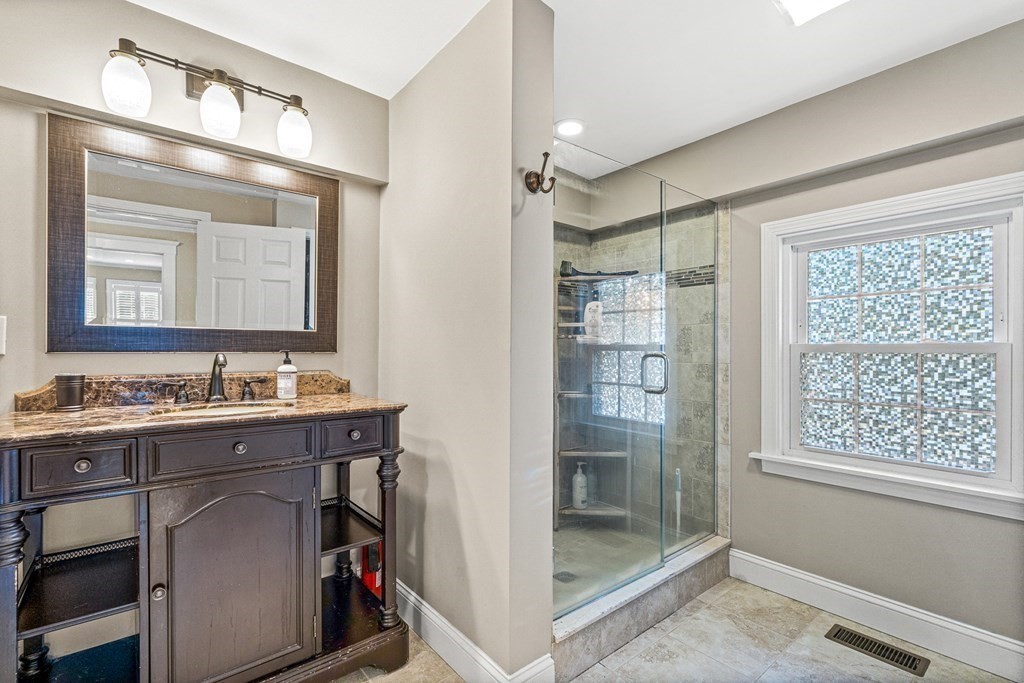 7 Perkins Avenue Reading, MA 01867 - Photo 26 of 42 a bathroom with a sink and a mirror