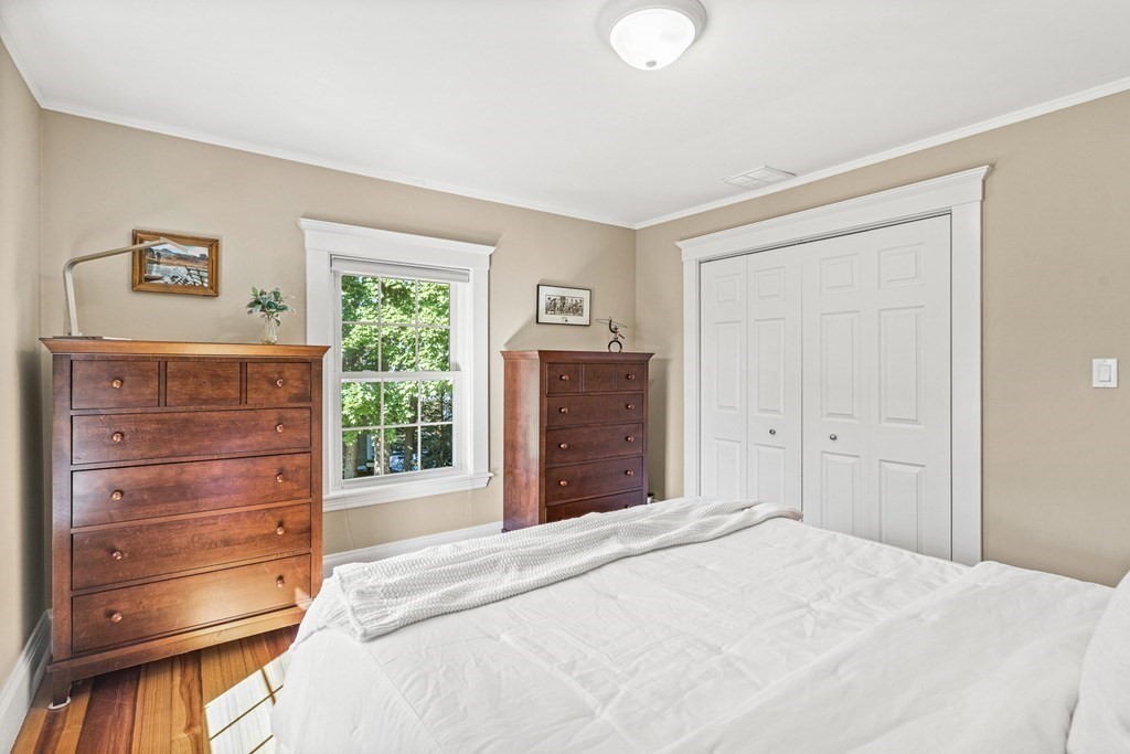 7 Perkins Avenue Reading, MA 01867 - Photo 32 of 42 a bedroom with a bed and a dresser