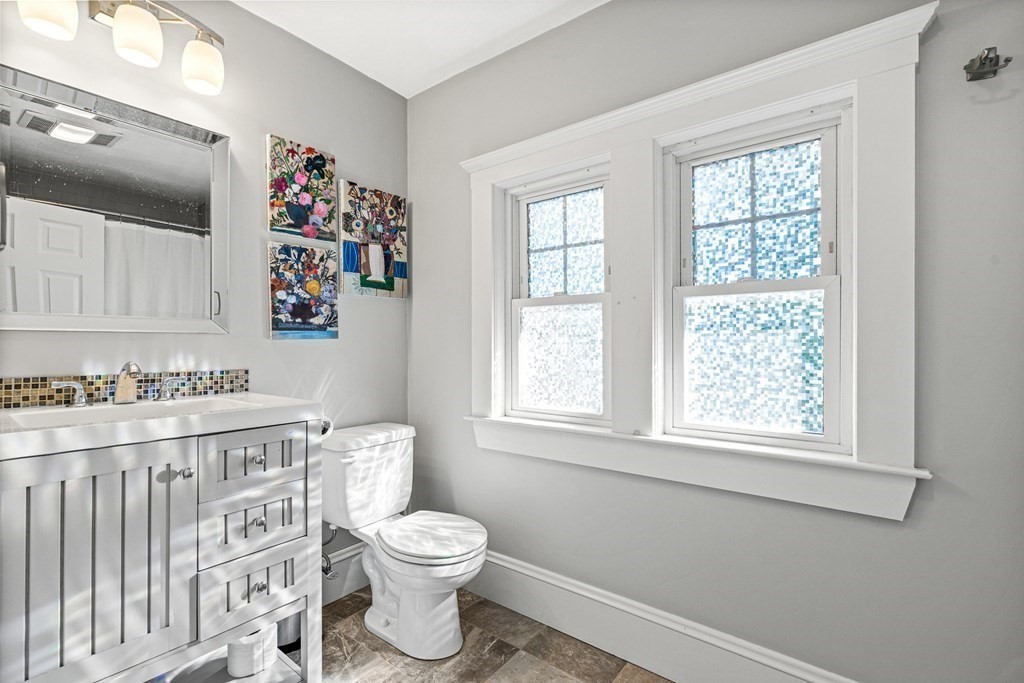 7 Perkins Avenue Reading, MA 01867 - Photo 35 of 42 a bathroom with a toilet a sink and a window