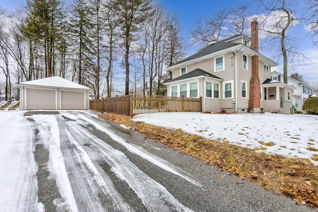 7 Perkins Avenue Reading, MA 01867 - Photo 41 of 42 a front view of a house with a yard covered with snow