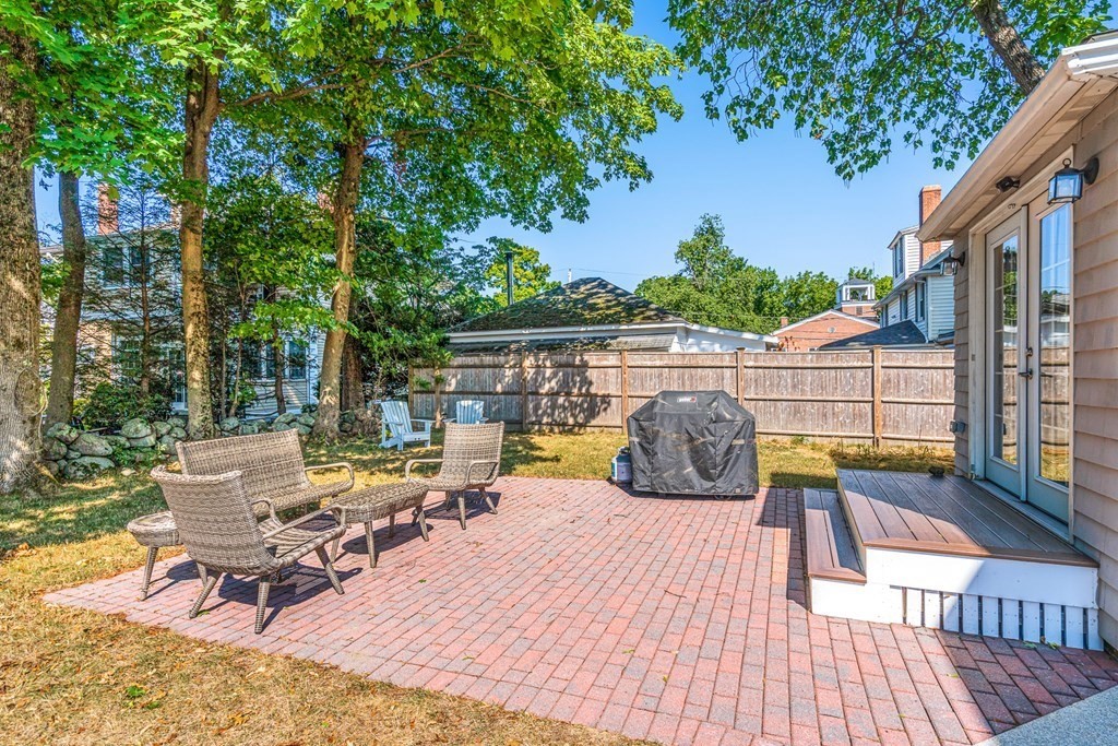 7 Perkins Avenue Reading, MA 01867 - Photo 42 of 42 a view of deck with table and chairs potted plants with wooden floor and fence