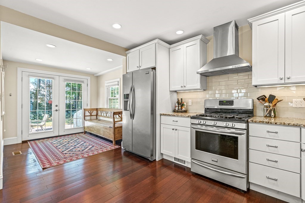 7 Perkins Avenue Reading, MA 01867 - Photo 5 of 42 a kitchen with a stove a refrigerator and a stove top oven