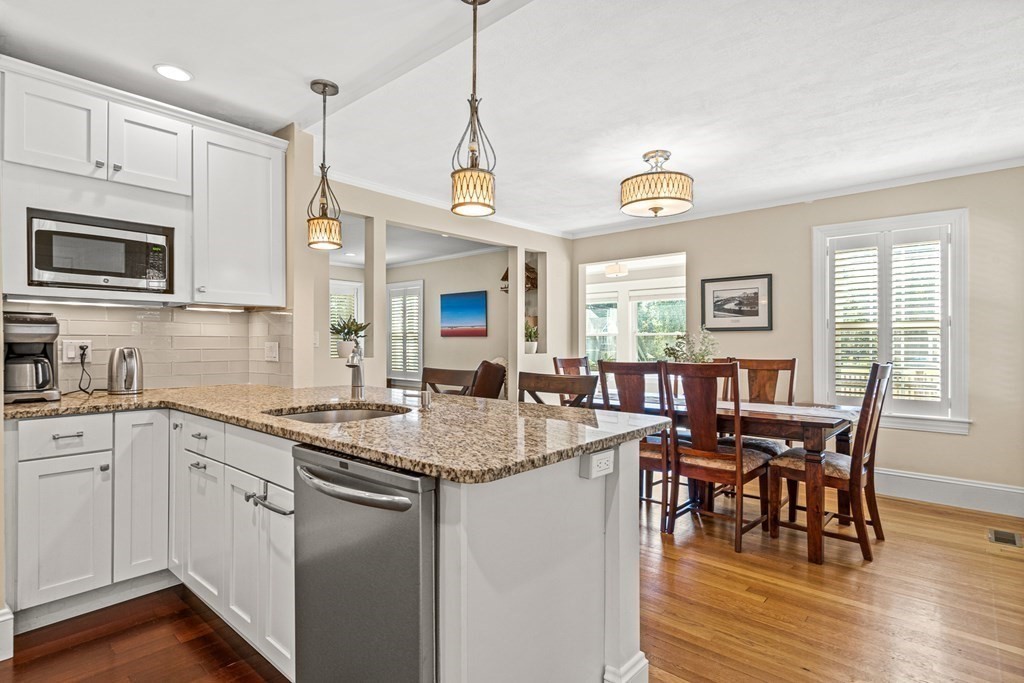 7 Perkins Avenue Reading, MA 01867 - Photo 8 of 42 a kitchen with stainless steel appliances granite countertop a dining table and chairs