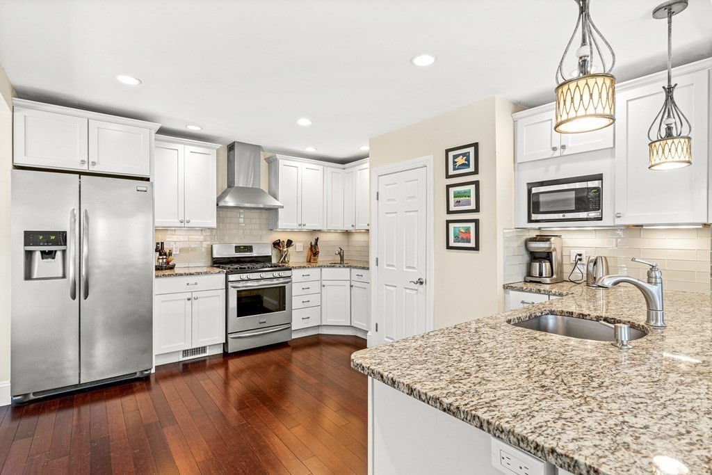 7 Perkins Avenue Reading, MA 01867 - Photo 9 of 42 a kitchen with granite countertop a sink cabinets stainless steel appliances and a counter top space