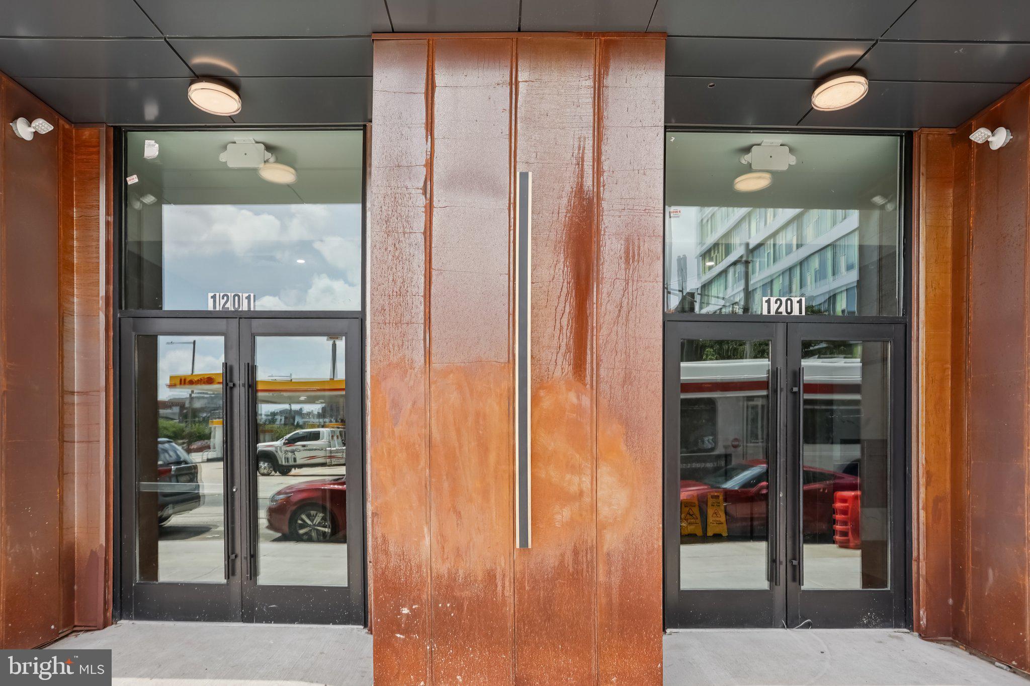 1201 Vine Street, Unit STUDIO Philadelphia, PA 19107 - Photo 18 of 29 a bathroom with a glass shower door and a mirror