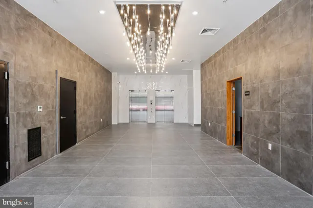a view of a hallway with chandelier
