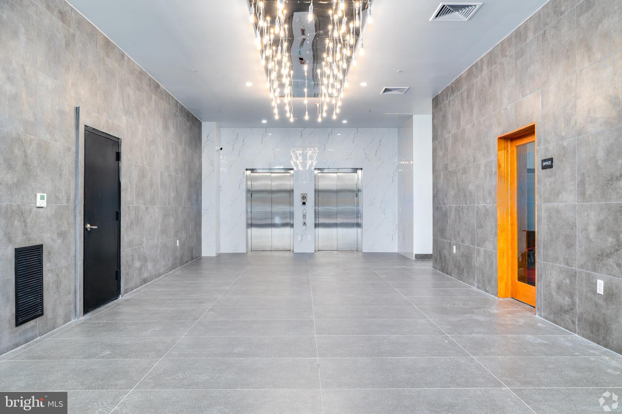 1201 Vine Street, Unit STUDIO Philadelphia, PA 19107 - Photo 23 of 29 a view of a kitchen with a sink and a refrigerator