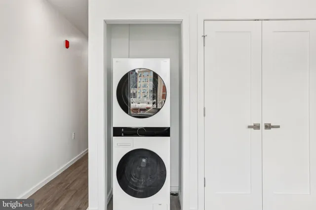 a view of a hallway with washer and dryer