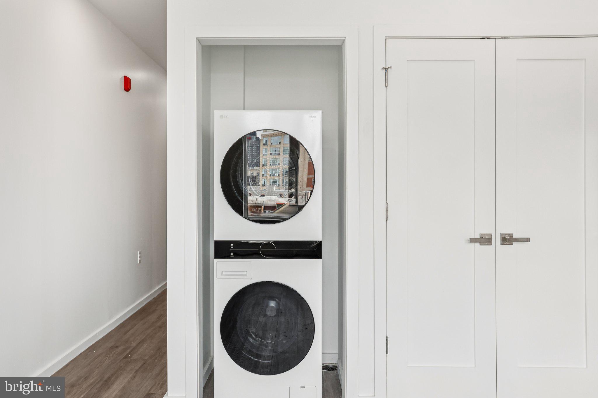 1201 Vine Street, Unit STUDIO Philadelphia, PA 19107 - Photo 8 of 29 a view of a hallway with washer and dryer