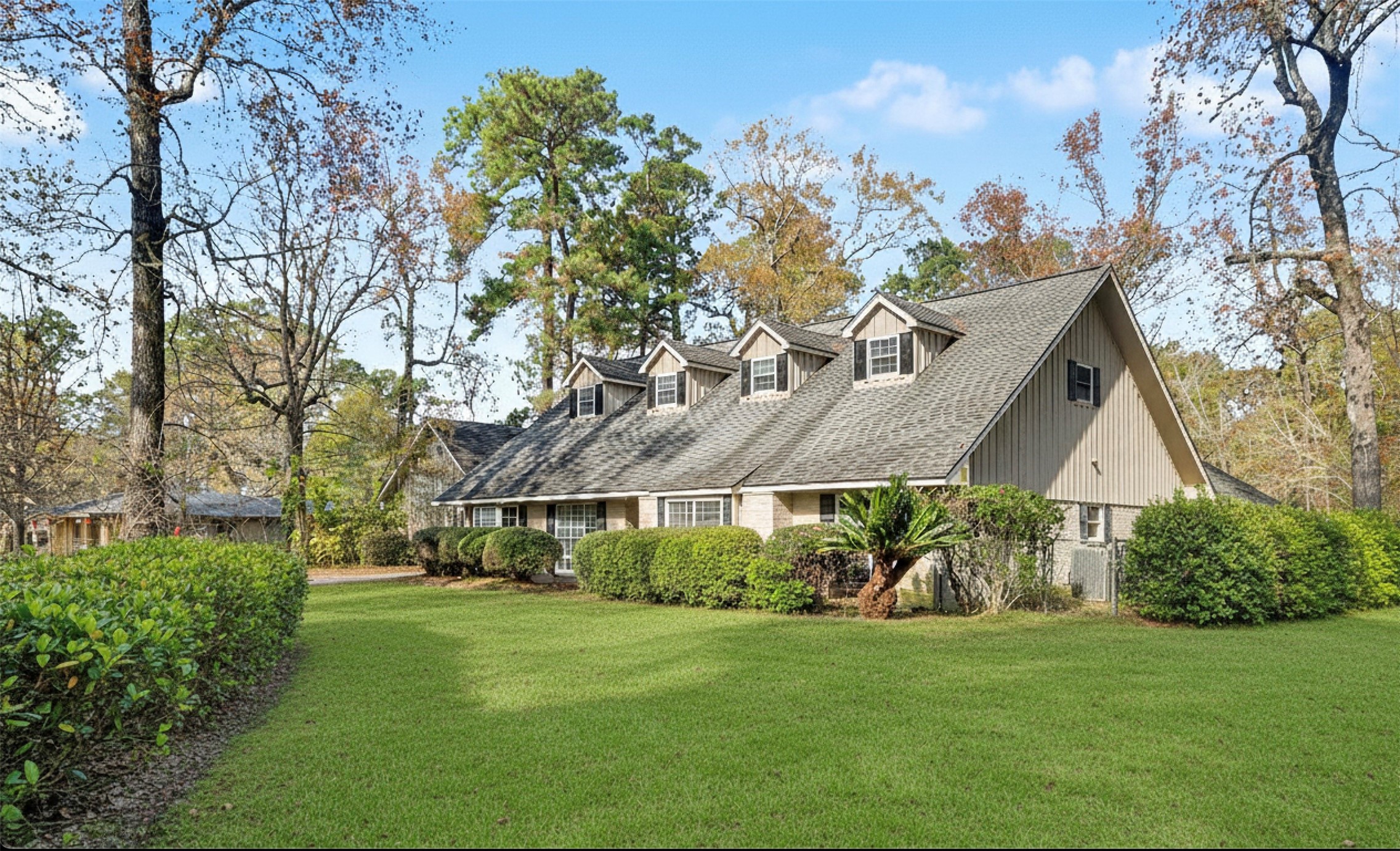 Charming two-story home in Kingwood.  Never Flooded with attached guest quarters,  gabled roof and dormer windows, surrounded by greenery and mature trees. The spacious front lawn offers excellent curb appeal in a peaceful, natural setting.