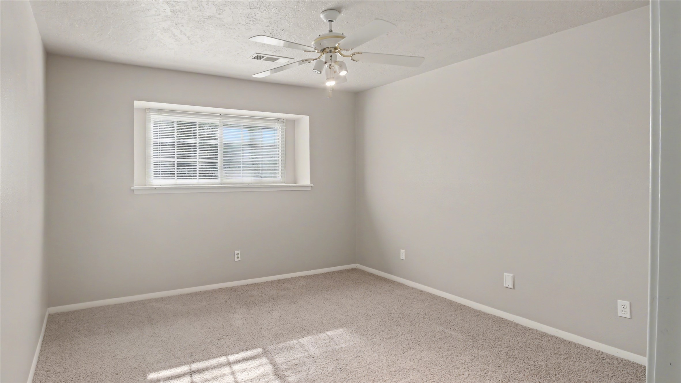 1431 Walnut Lane Houston, TX 77339 - Photo 17 of 46 This cozy bedroom, bathed in natural light and featuring soft carpeting, complements the home's modern updates, including an elegantly renovated shower in the primary bathroom.