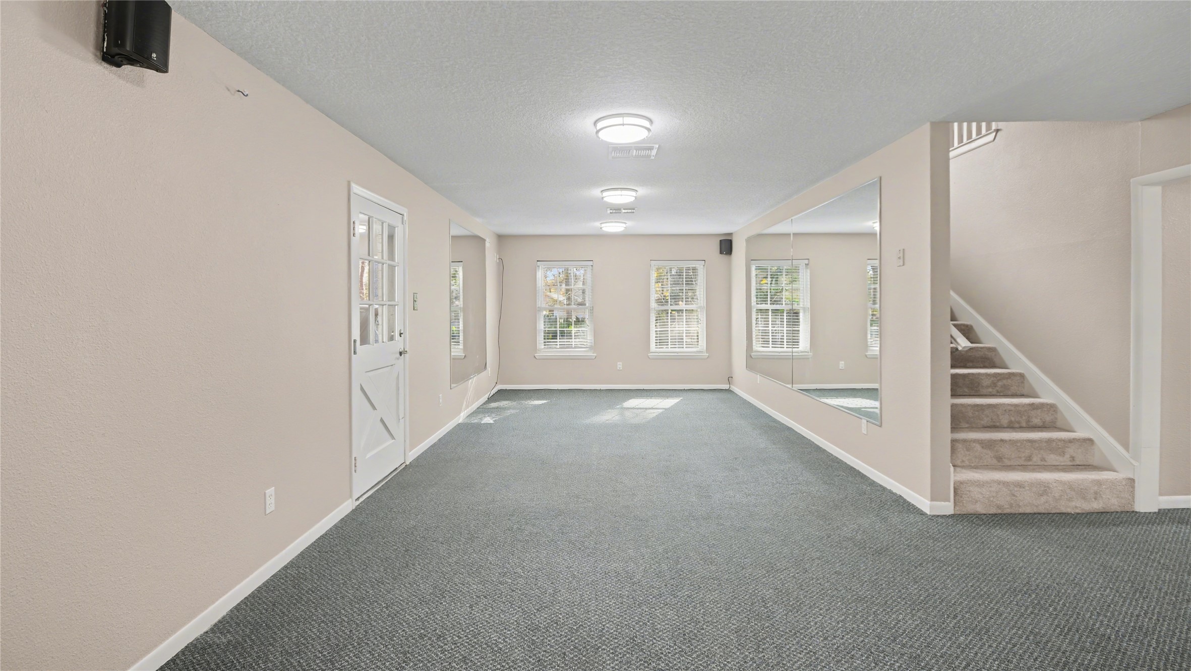 1431 Walnut Lane Houston, TX 77339 - Photo 34 of 46 A staircase leads to the upper level, and a large wall mirror enhances the sense of space ideal for gym/ craft room or den