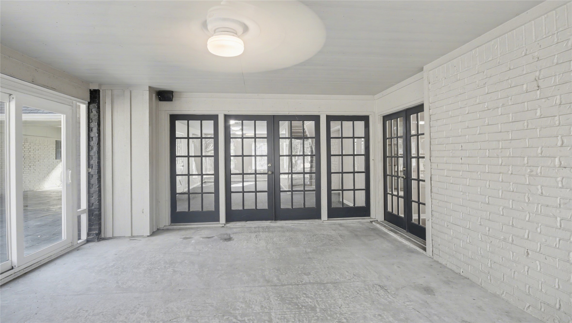 1431 Walnut Lane Houston, TX 77339 - Photo 38 of 47 This inviting sunroom, bathed in natural light with elegant French doors and a serene ambiance, offers the perfect spot for relaxation and enjoying the outdoors from the comfort of your home.