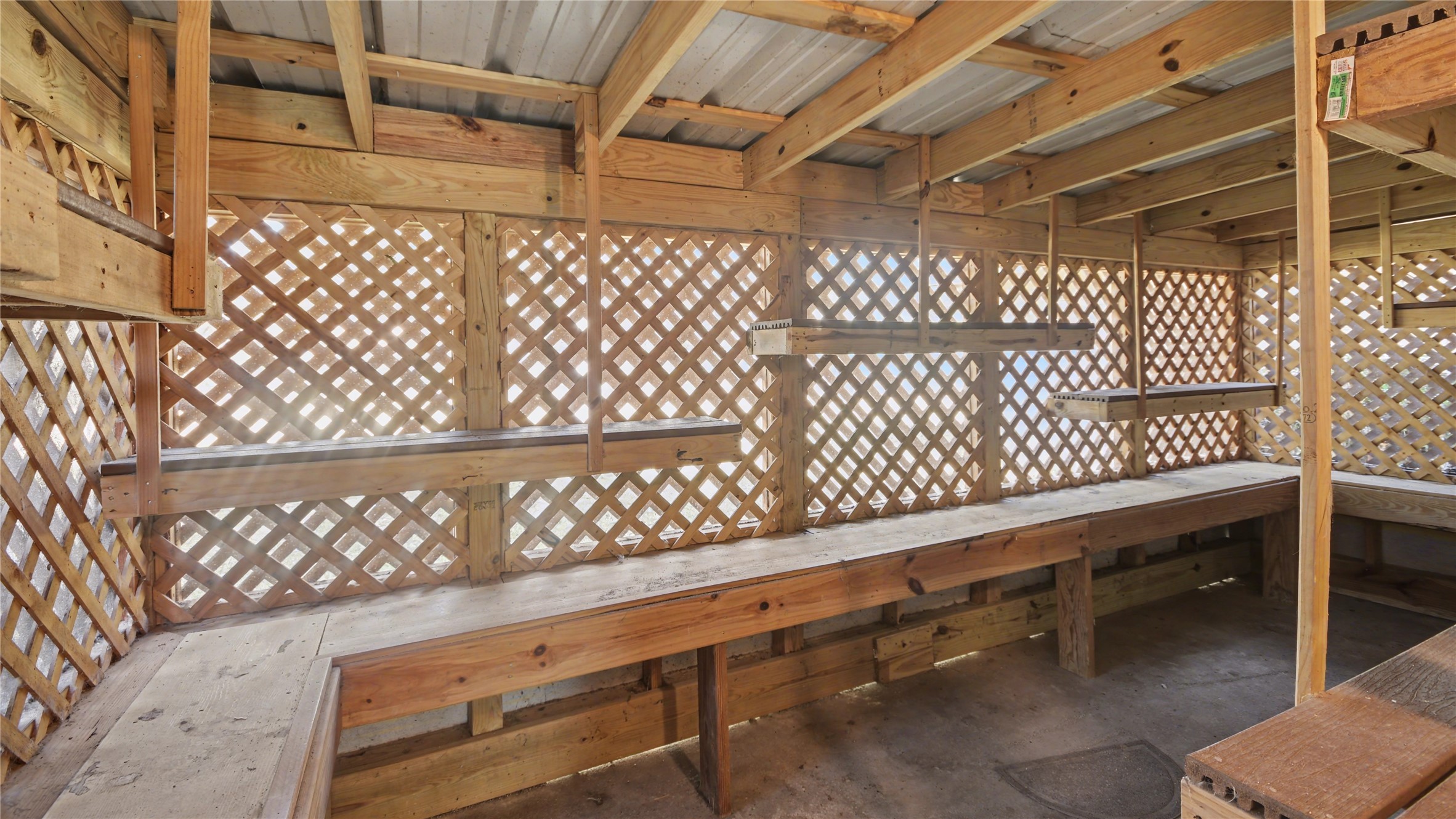 1431 Walnut Lane Houston, TX 77339 - Photo 39 of 44 Enclosed outdoor “catio” with built-in shelving and airflow — a versatile space ideal for pets, a hobby area, gardening prep, or additional covered storage.