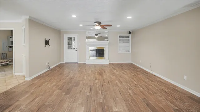 a view of a kitchen with wooden floor and a sink