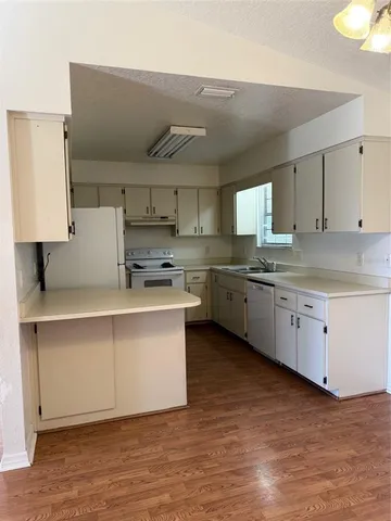 a kitchen with stainless steel appliances a sink stove and cabinets