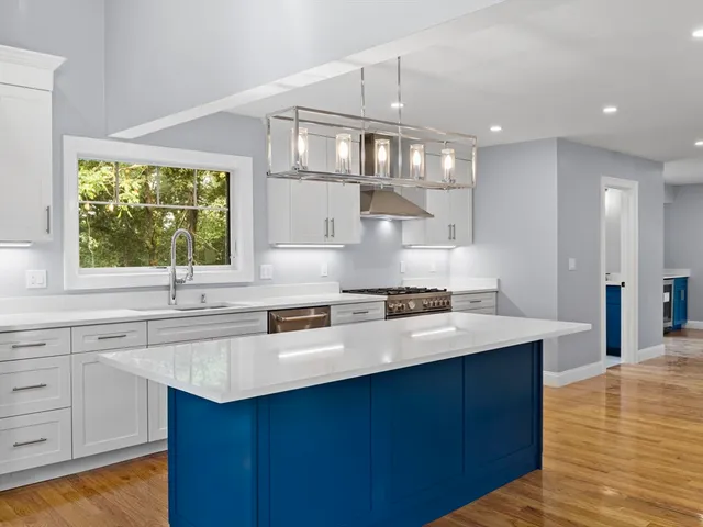 a kitchen with stainless steel appliances a sink stove and cabinets