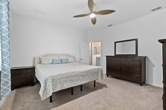a bedroom with a bed and a dresser