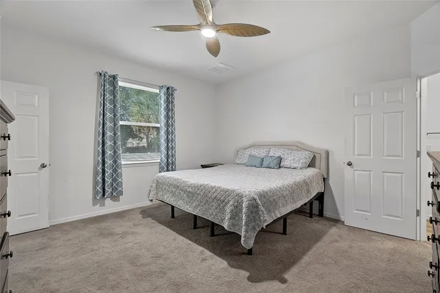 a bedroom with a bed and window