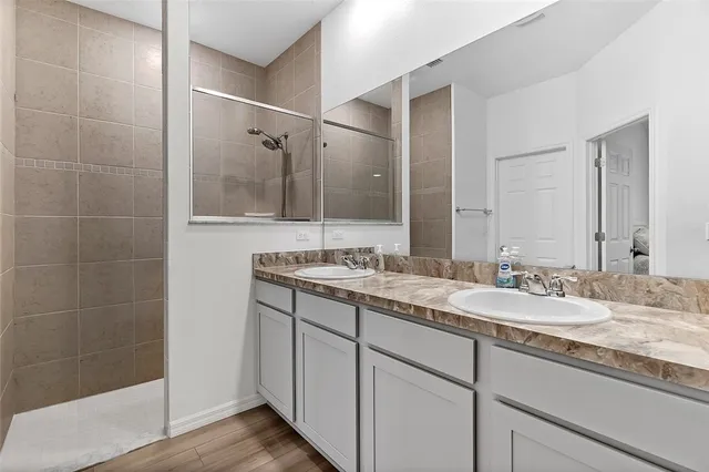 a bathroom with a granite countertop sink mirror and double