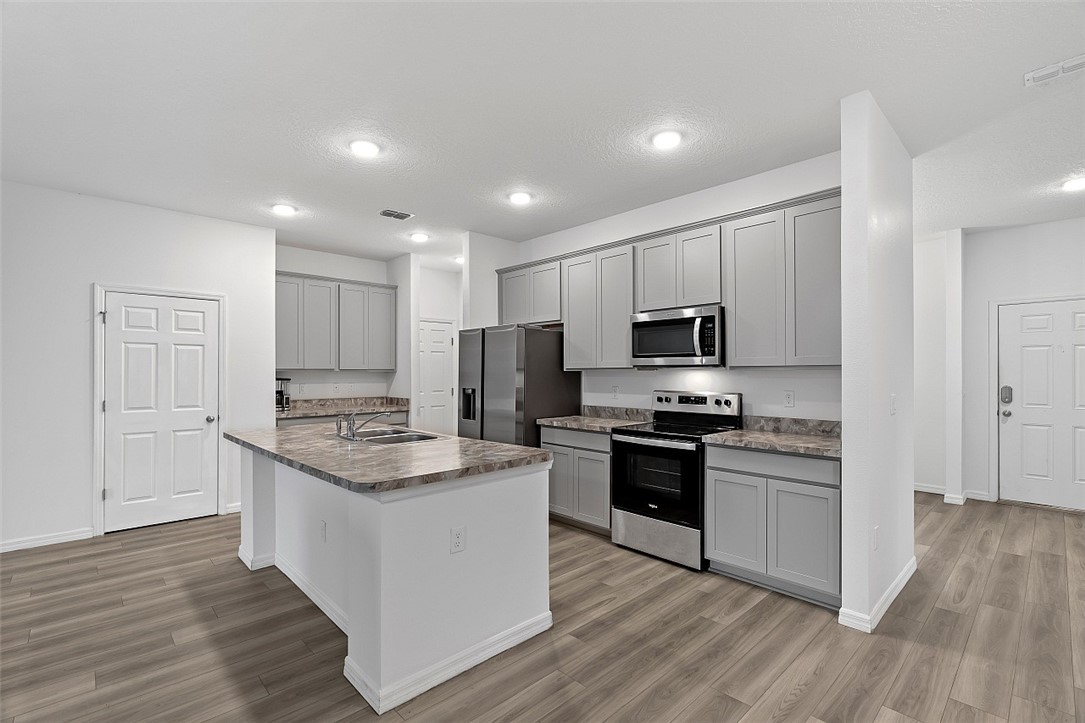 633 Belfast Terrace Sebastian, FL 32958 - Photo 3 of 36 a kitchen with stainless steel appliances granite countertop a stove top oven a sink and a refrigerator