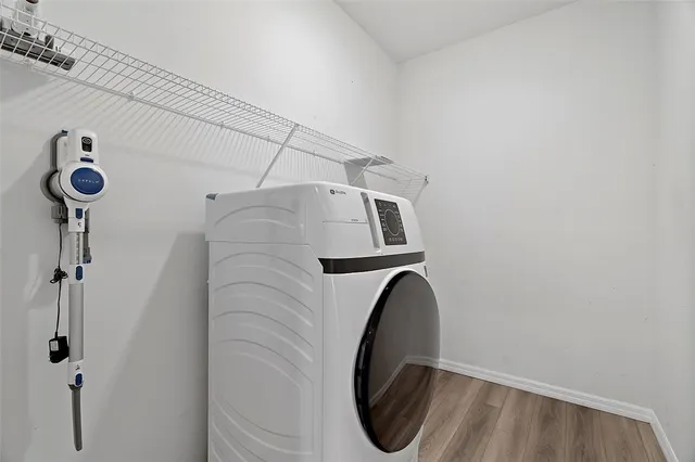 a close view of a utility room with dryer and washer