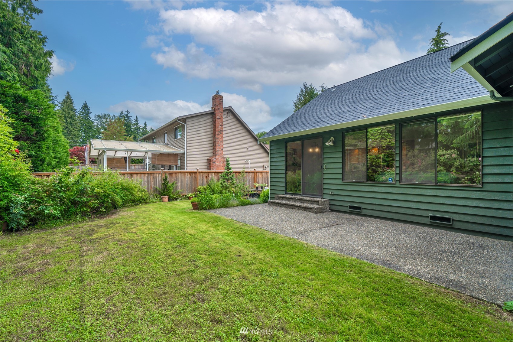 1516 243rd Place Southeast Bothell, WA 98021 - Photo 24 of 30 a view of a house with backyard and garden