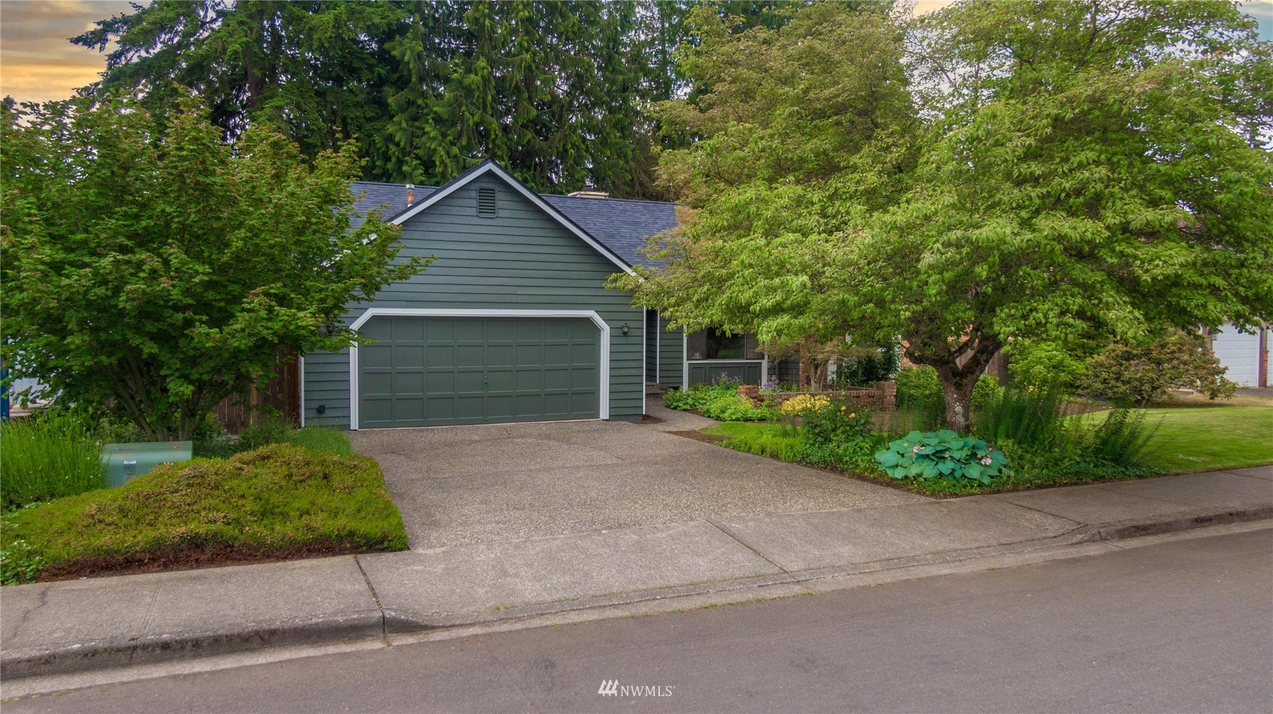 1516 243rd Place Southeast Bothell, WA 98021 - Photo 26 of 30 a front view of a house with a yard and garage