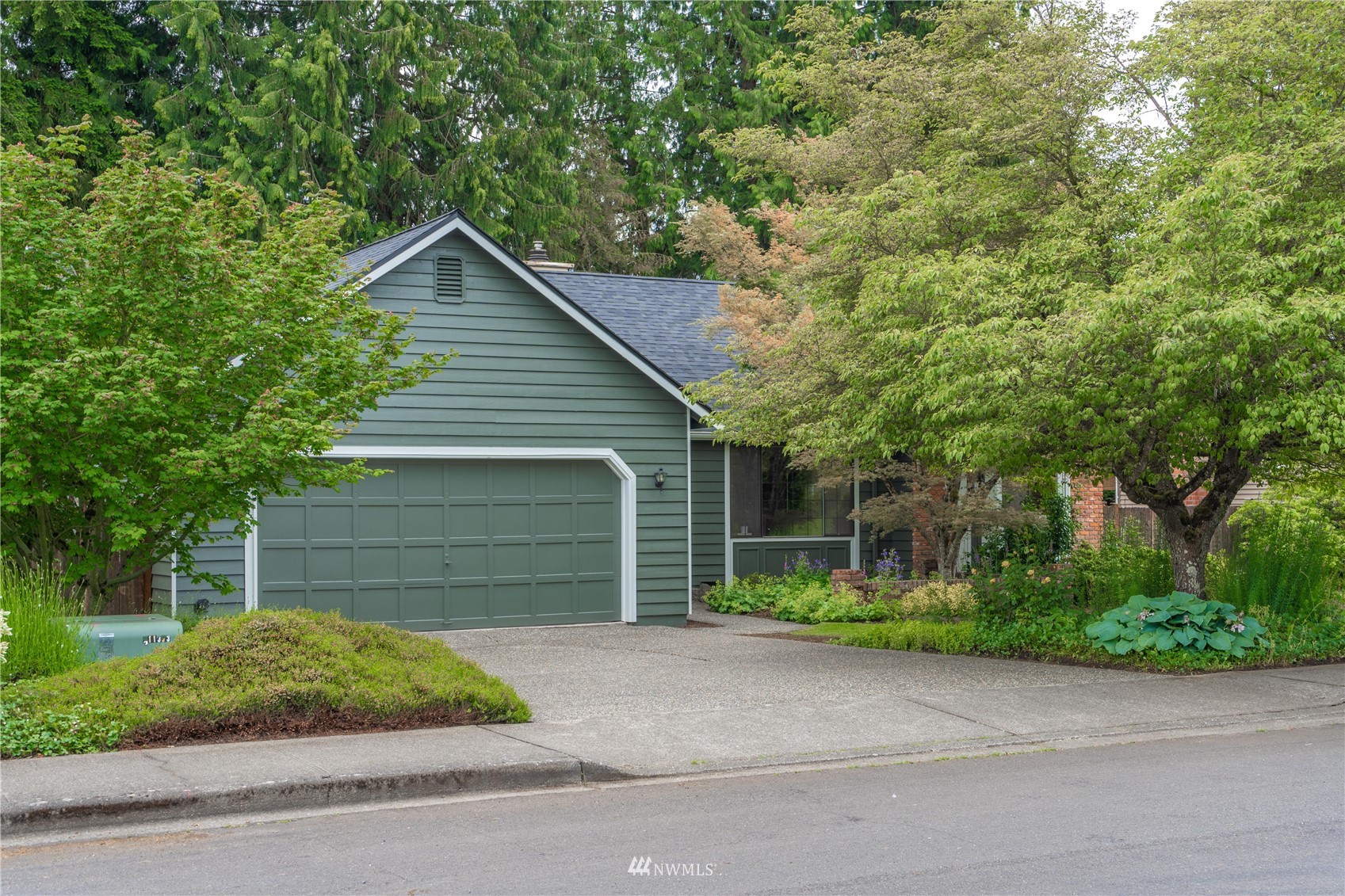 1516 243rd Place Southeast Bothell, WA 98021 - Photo 3 of 30 a front view of a house with a yard and garage