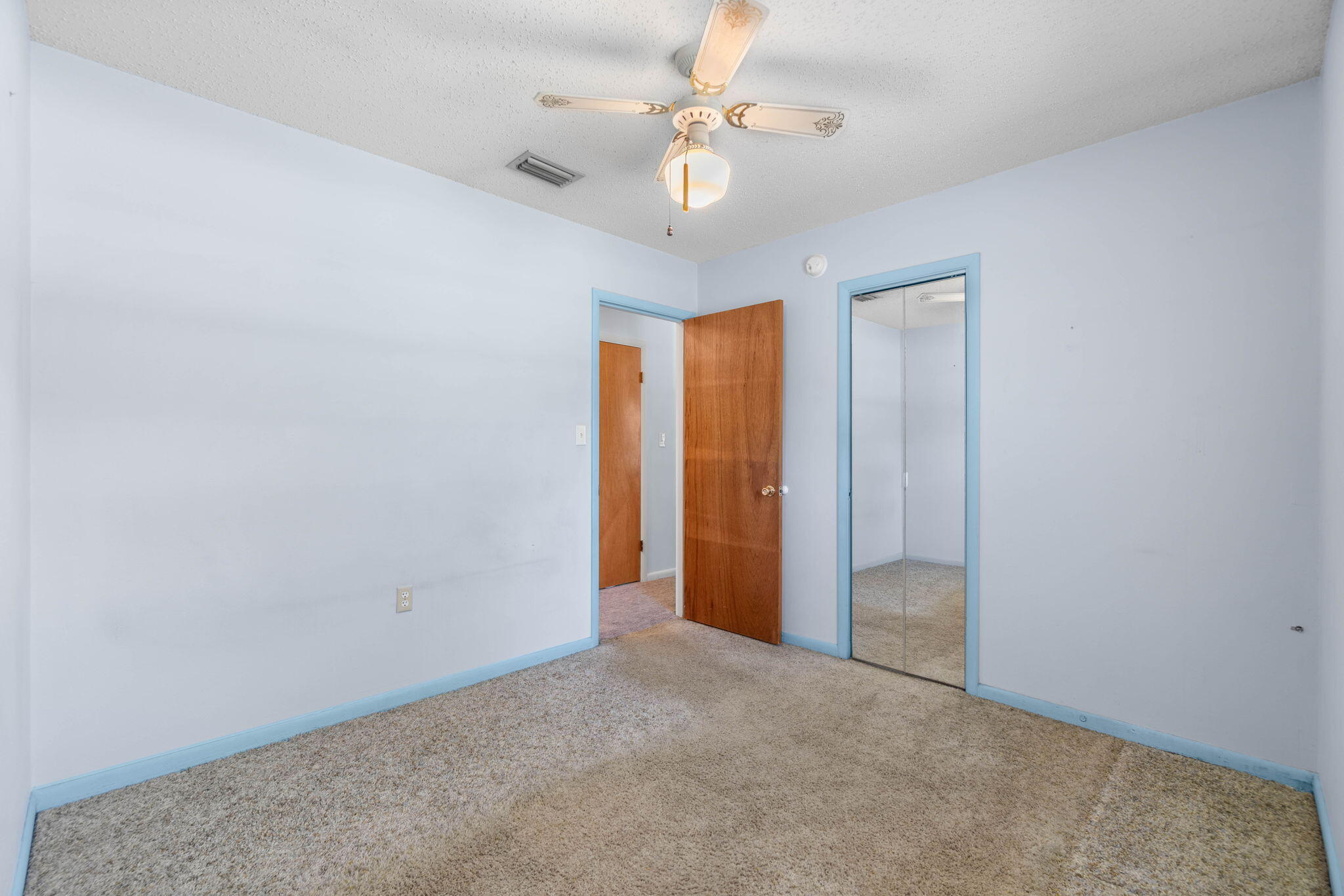 55 12th Street Shalimar, FL 32579 - Photo 11 of 22 an empty room with a ceiling fan and a window