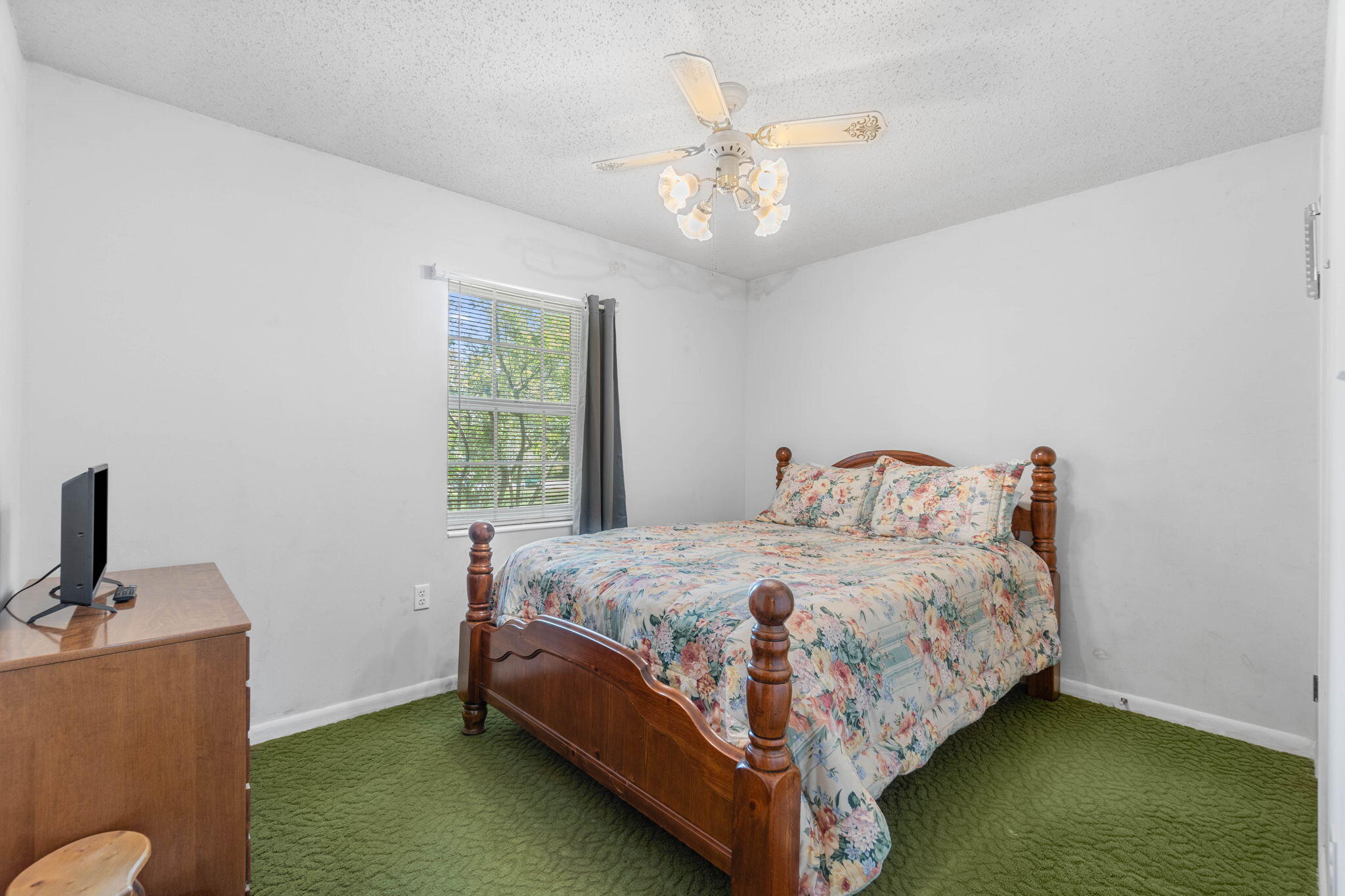 55 12th Street Shalimar, FL 32579 - Photo 12 of 22 a bedroom with a bed and a chandelier