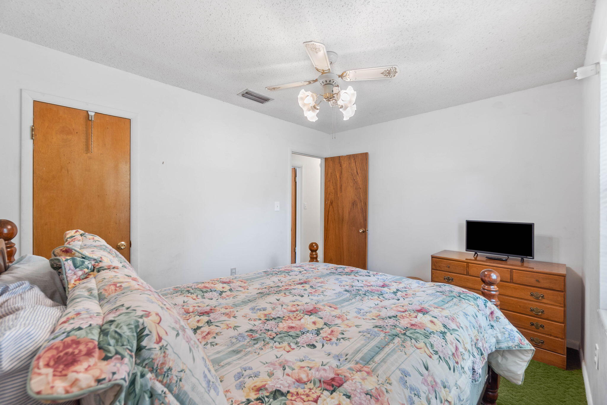 55 12th Street Shalimar, FL 32579 - Photo 13 of 22 a bedroom with a bed and a flat screen tv