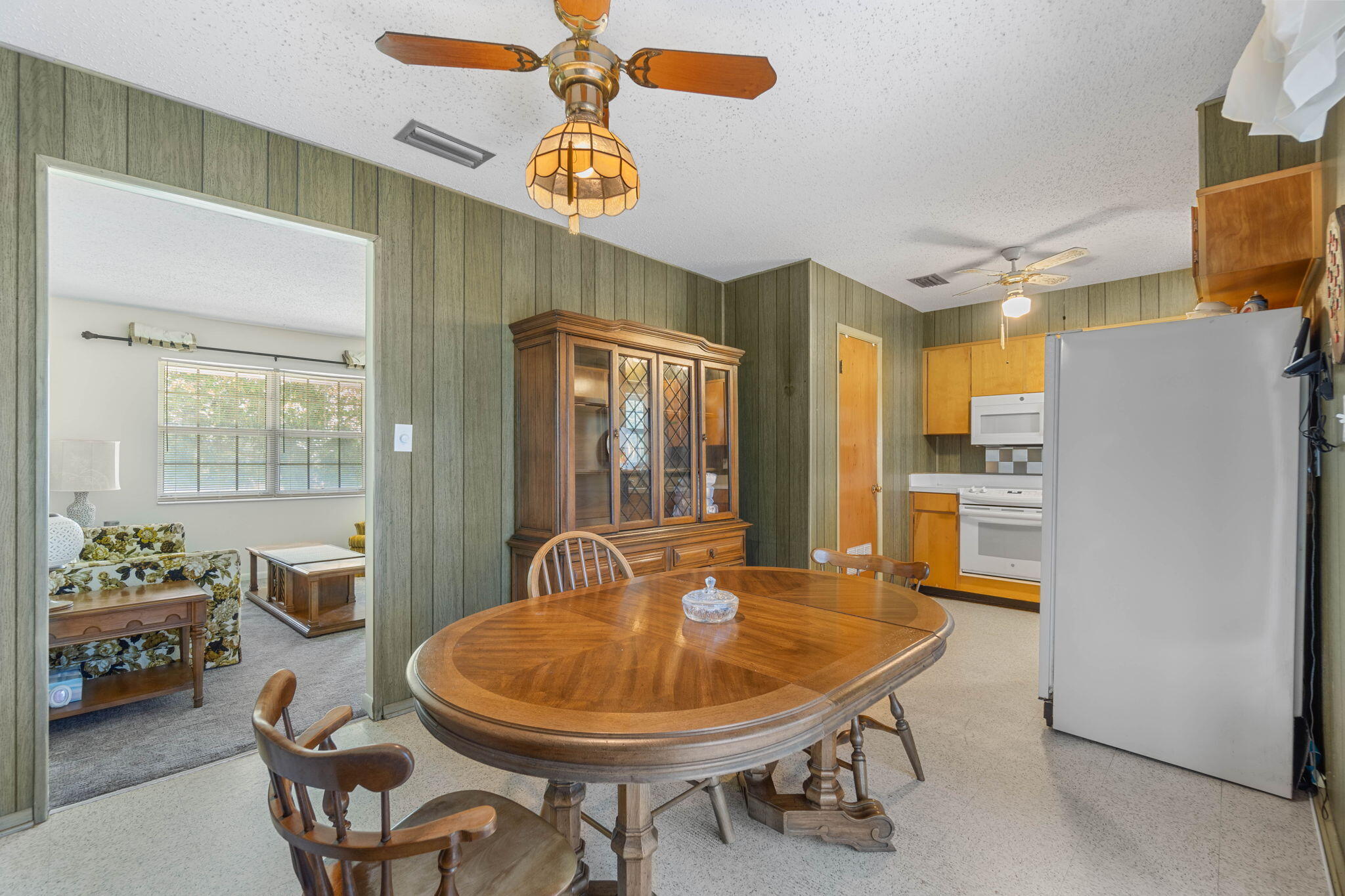 55 12th Street Shalimar, FL 32579 - Photo 7 of 22 a dining room with furniture a kitchen view and a chandelier