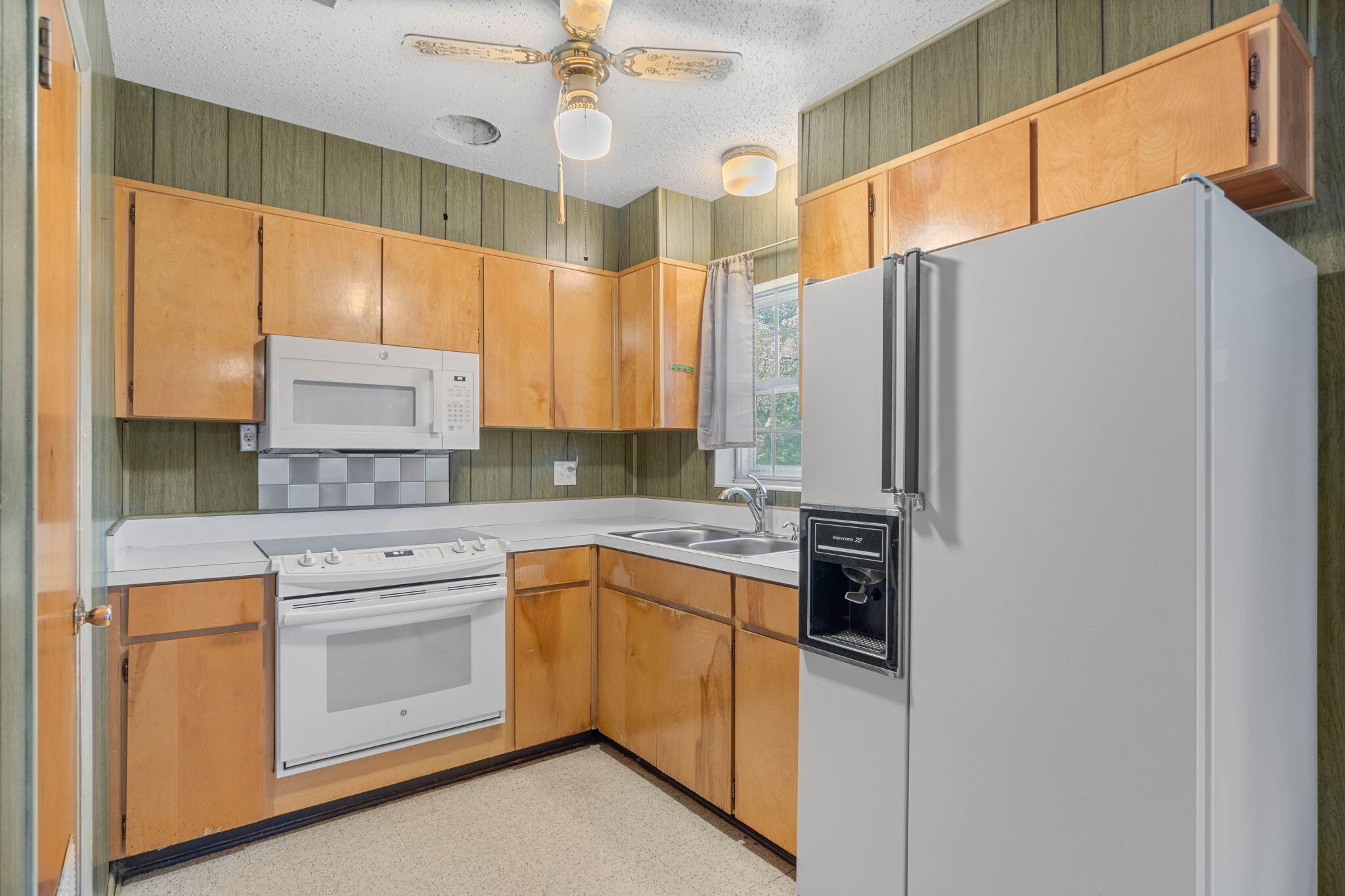 55 12th Street Shalimar, FL 32579 - Photo 8 of 22 a kitchen with a refrigerator a sink and cabinets