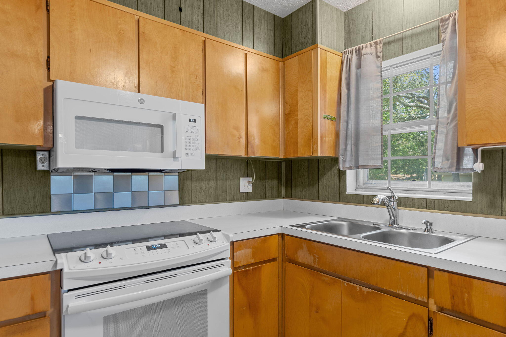 55 12th Street Shalimar, FL 32579 - Photo 9 of 22 a kitchen with a sink a cabinets and window