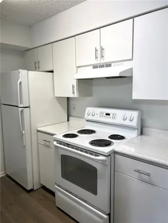 a kitchen with a stove and a refrigerator