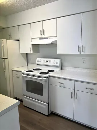 a kitchen with stainless steel appliances granite countertop a sink a stove and a refrigerator