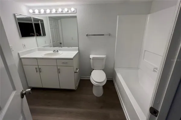 a bathroom with a sink toilet and mirror