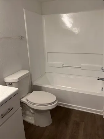 a bathroom with a toilet and a bath tub