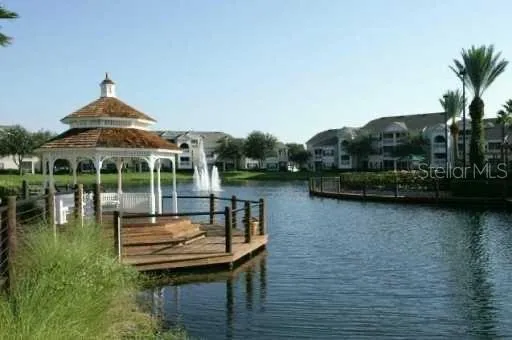 a view of a lake with a deck and a garden