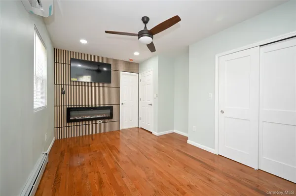 a view of empty room with kitchen and sink
