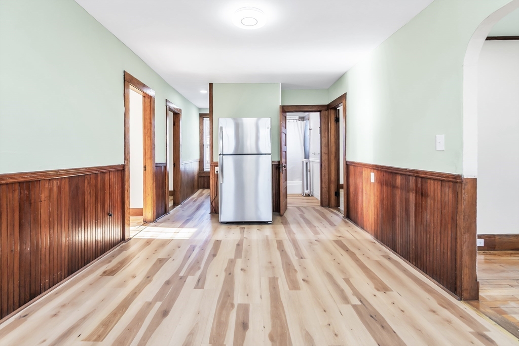 144 A Street Lowell, MA 01851 - Photo 13 of 32 a view of a room with wooden floor and stairs