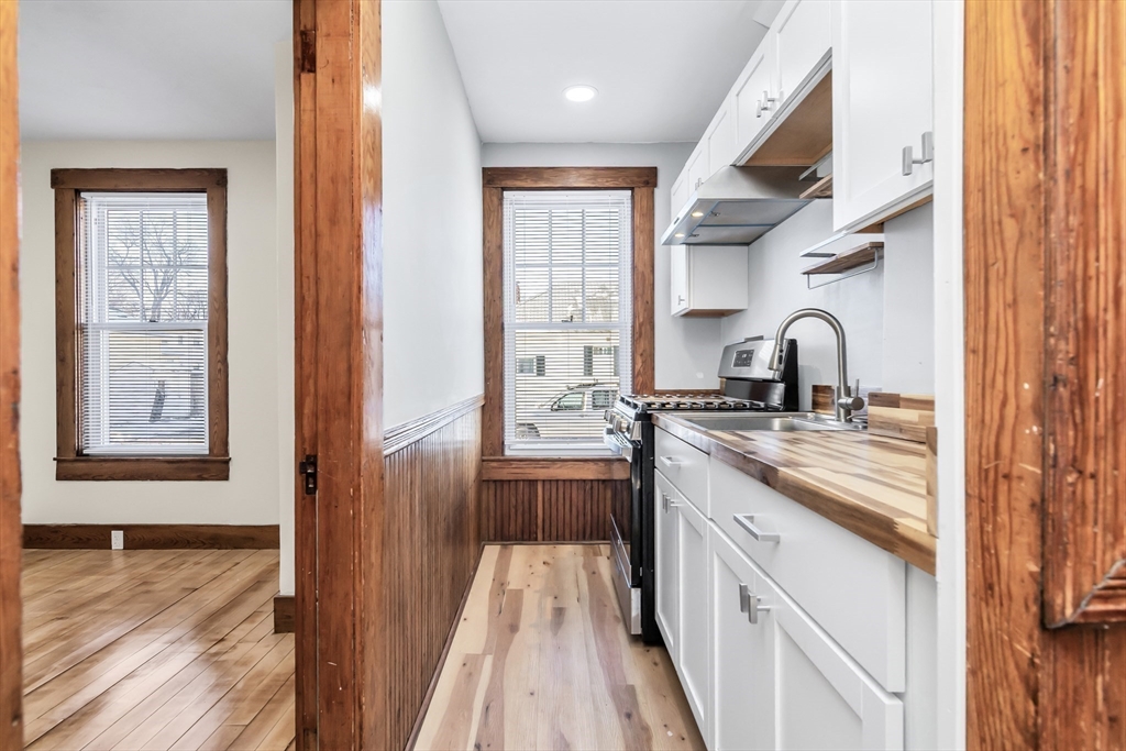 144 A Street Lowell, MA 01851 - Photo 16 of 32 a kitchen with a sink a counter top space and appliances