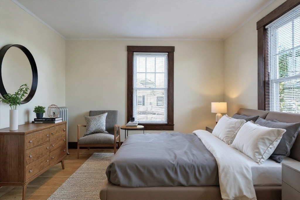 144 A Street Lowell, MA 01851 - Photo 20 of 32 a bedroom with a bed a mirror and a window